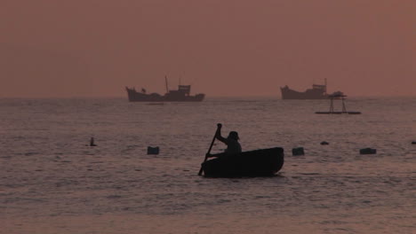 a man in a boat with ships in the background