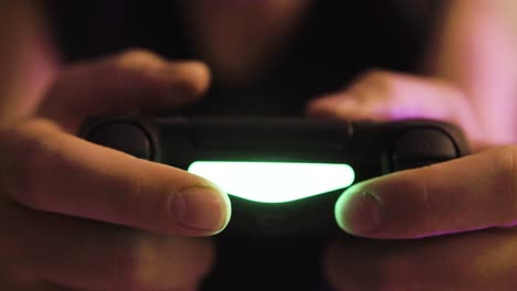 Playing-Shooter-Video-Game-on-Console,-Dark-Environment-Room,-Hands-on-Controller-Point-of-View