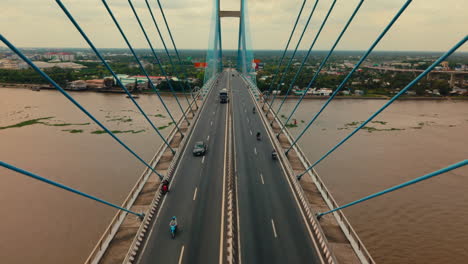 cable-stayed bridge over a river with cityscape view