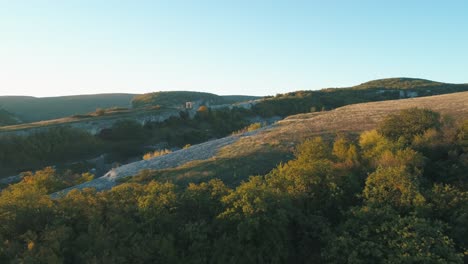 aerial view of mountainous landscape with valley and forest