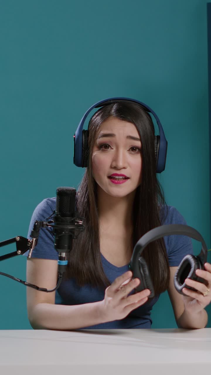 Woman recording a podcast with headphones and microphone
