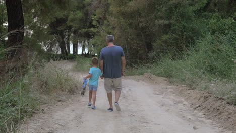 Child-walking-through-the-wood-with-grandpa