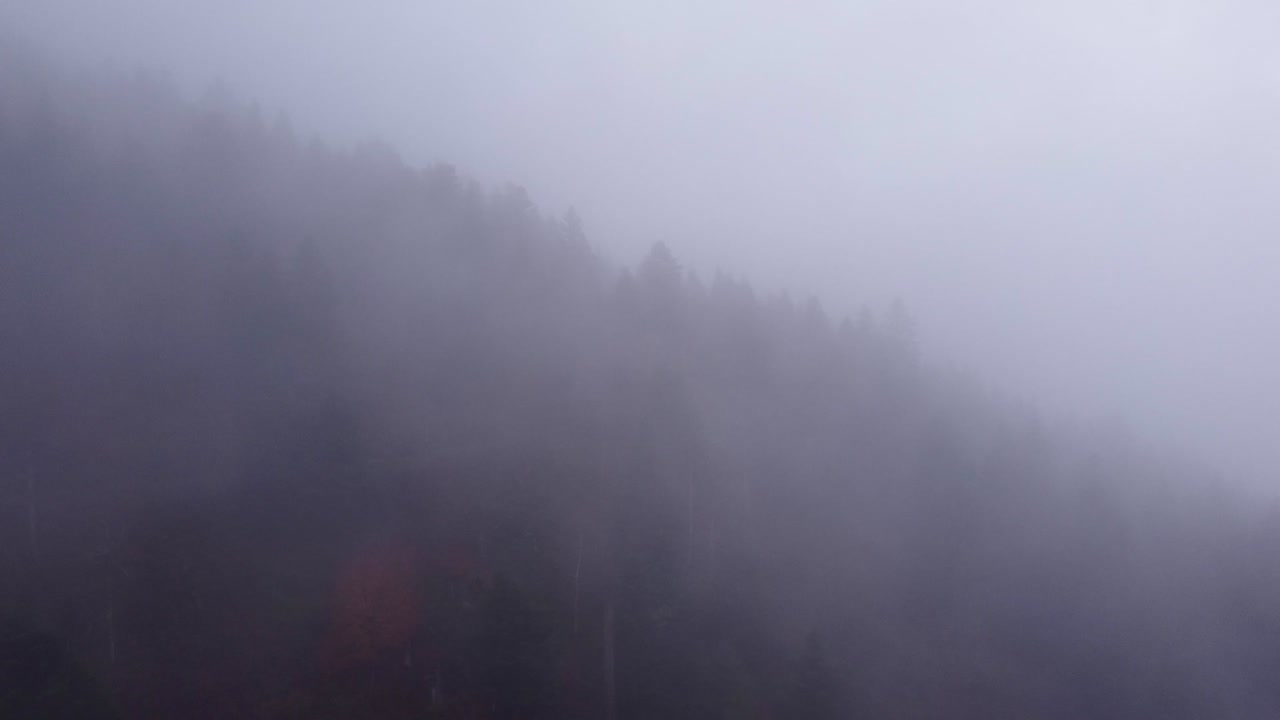 Aerial view of mountain moving clouds during autumn fall in Vosges, France, 4K