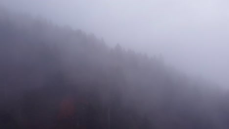 Aerial-view-of-mountain-moving-clouds-during-autumn-fall-in-Vosges,-France,-4K