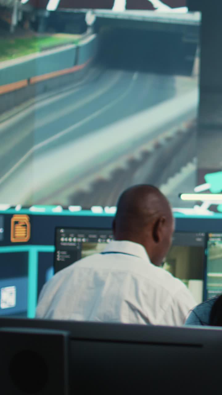 Professionals Monitoring Data and Traffic in a Modern Control Room