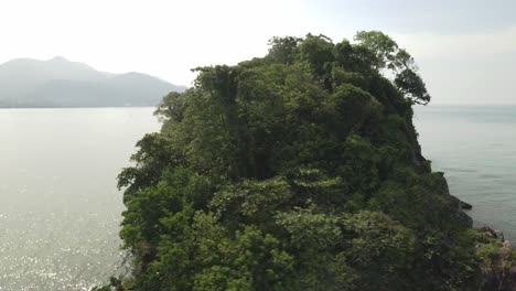 Aerial-orbit-shot-of-a-small-deserted-tropical-island-in-South-east-Asia