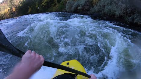 white water kayaking on a river surf wave