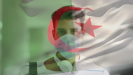 Animation-Der-Flagge-Algeriens,-Die-Während-Der-Covid-19-Pandemie-über-Einem-Mann-Mit-Gesichtsmaske-Weht