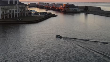 speedboat travels fast near the building of southern yacht club in west end point in new orleans, usa. tracking shot
