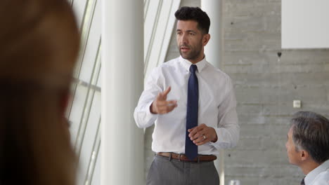 businessman leading meeting at boardroom table shot on r3d