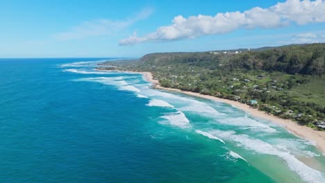 north shore oahu as seen from above, drone footage of hale'iwa and big waves on bright blue pacific ocean