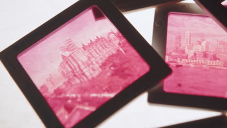 magnifying glass and colour slides on backlit white background