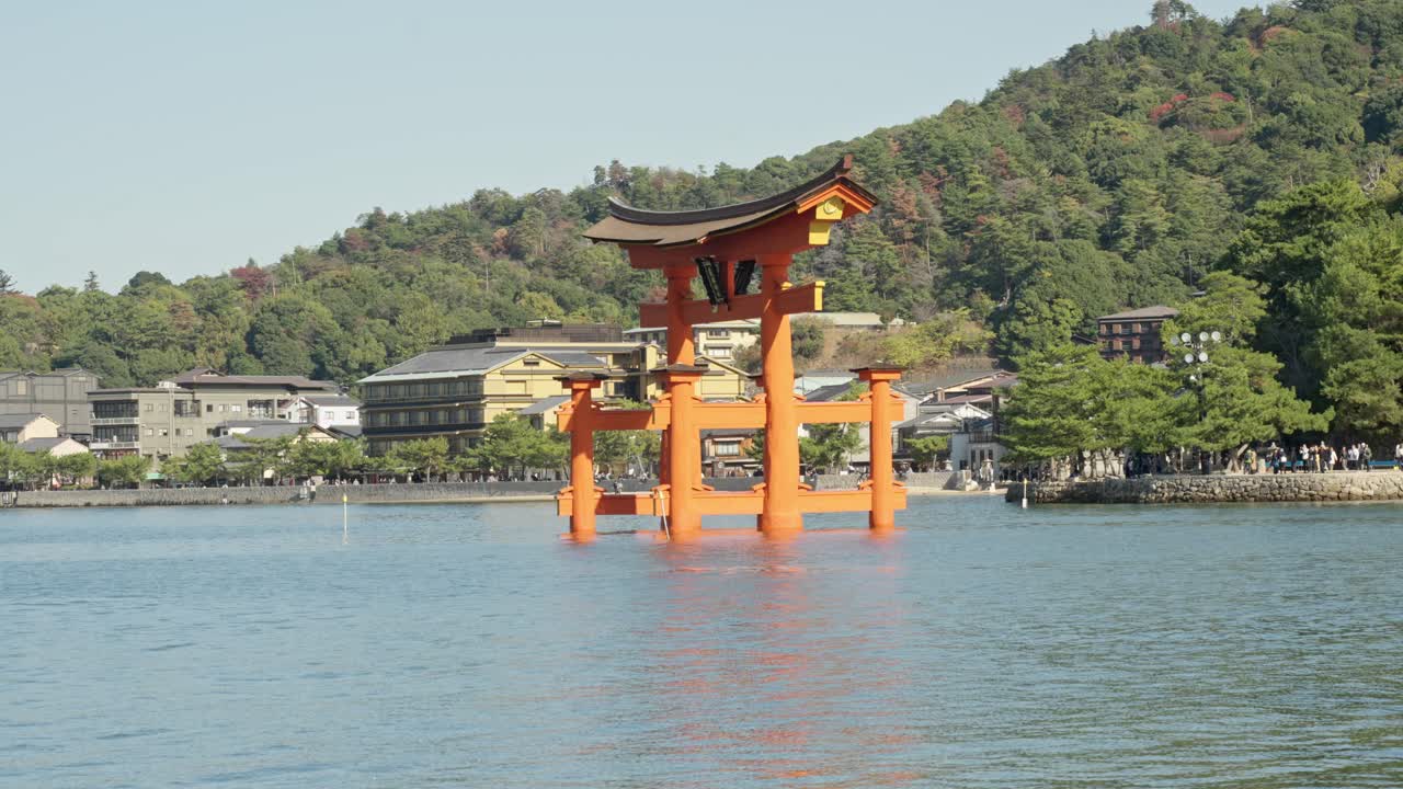 A captivating scene of the Itsukushima Shrine Torii gate, perfectly reflected in the tranquil waters of Miyajima Island.