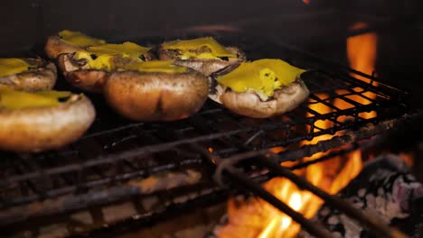 mushrooms with garlic butter - cheese barbecued on open fire, panning shot