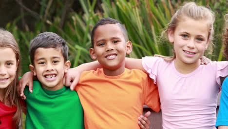 Smiling-pupils-sitting-on-bench