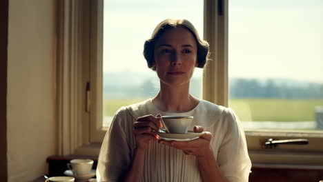 woman enjoying tea in a beautiful antique home