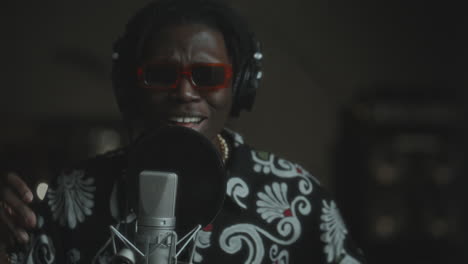 african american singer performing expressively in music recording studio