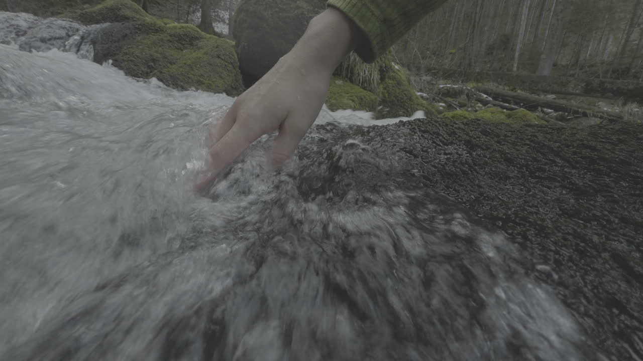 Hand in a mountain stream