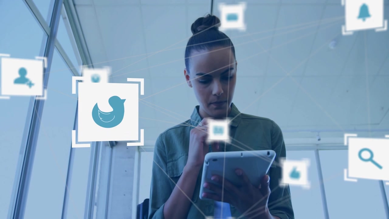 Young Woman Using Tablet with Social Media Icons in Modern Office