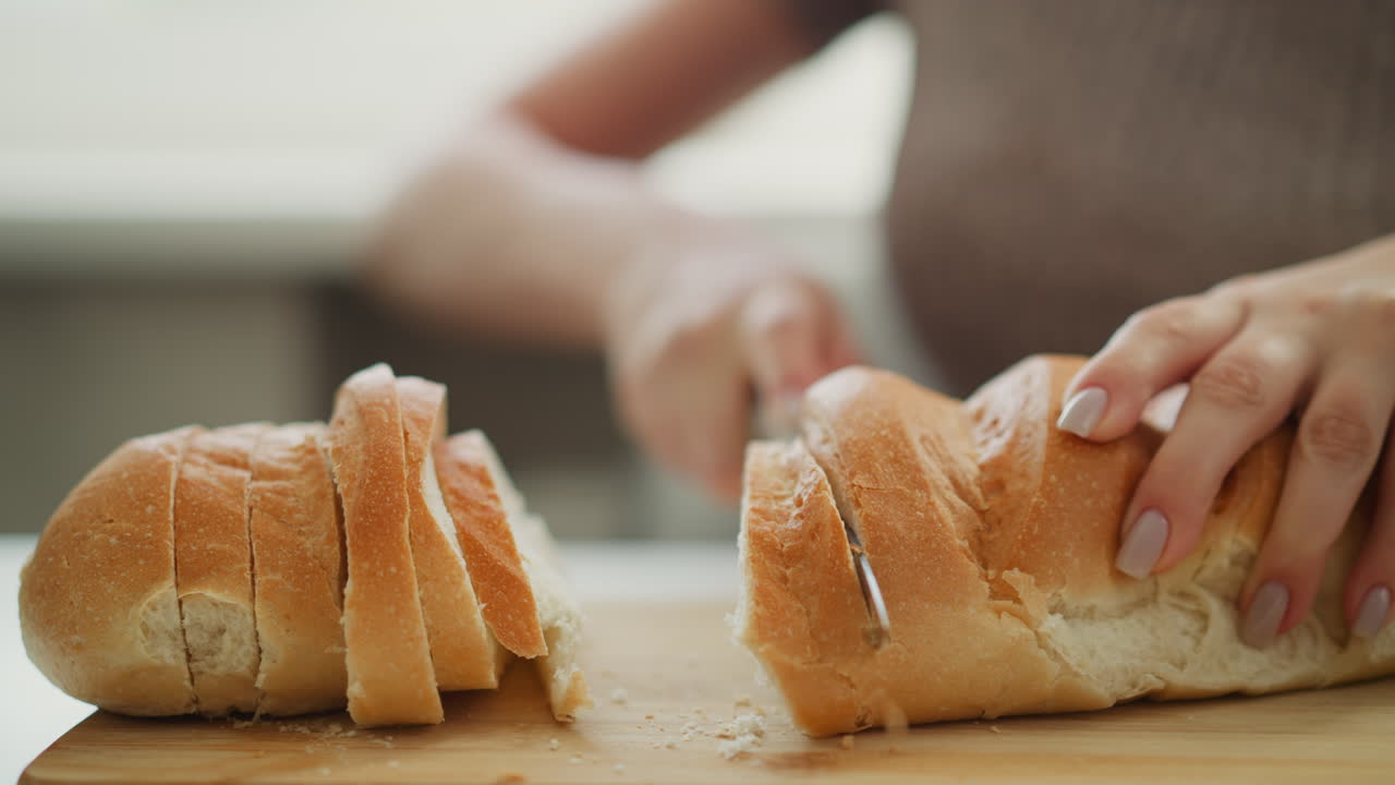 Woman cutting a loaf of bread