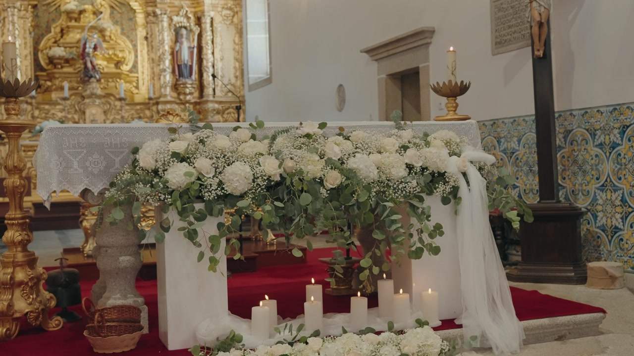 floral wedding altar with candles in ornate church interior