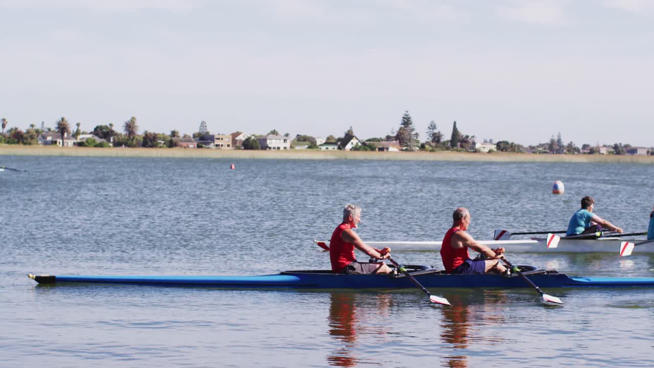 Four senior caucasian men and women rowing boat on a river