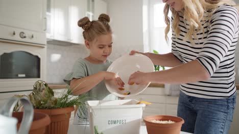 video of mother and daughter composting organic garbag