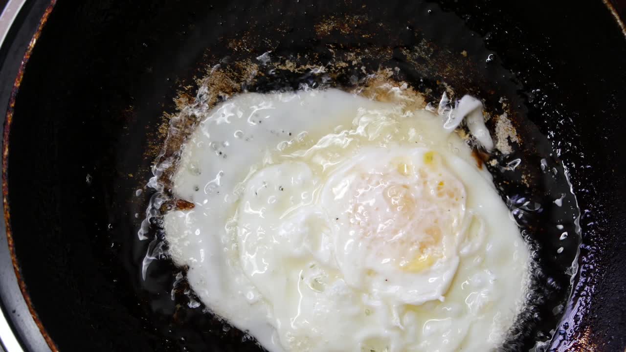 Fried eggs in the pan close up