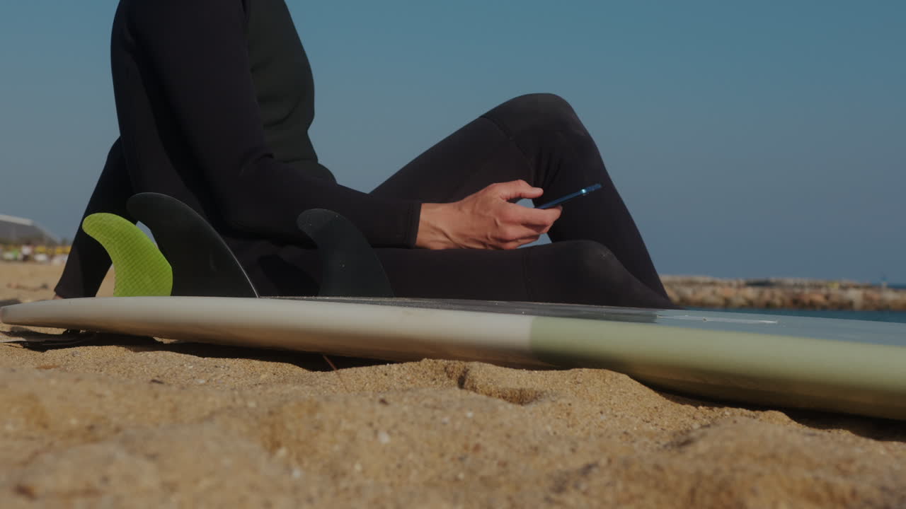 Surfer man walking to the beach at sunset preparing for surfing training and search for waves in Barcelona, spain, water, ocean exercise in sea with board, athletic male holiday or travel in vacation