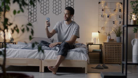 man on video call in bedroom