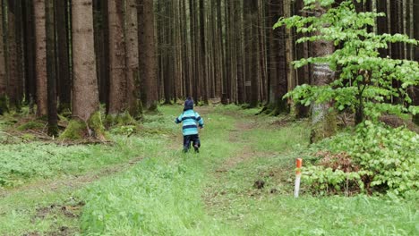 Young-boy-running-and-playing-in-the-forest