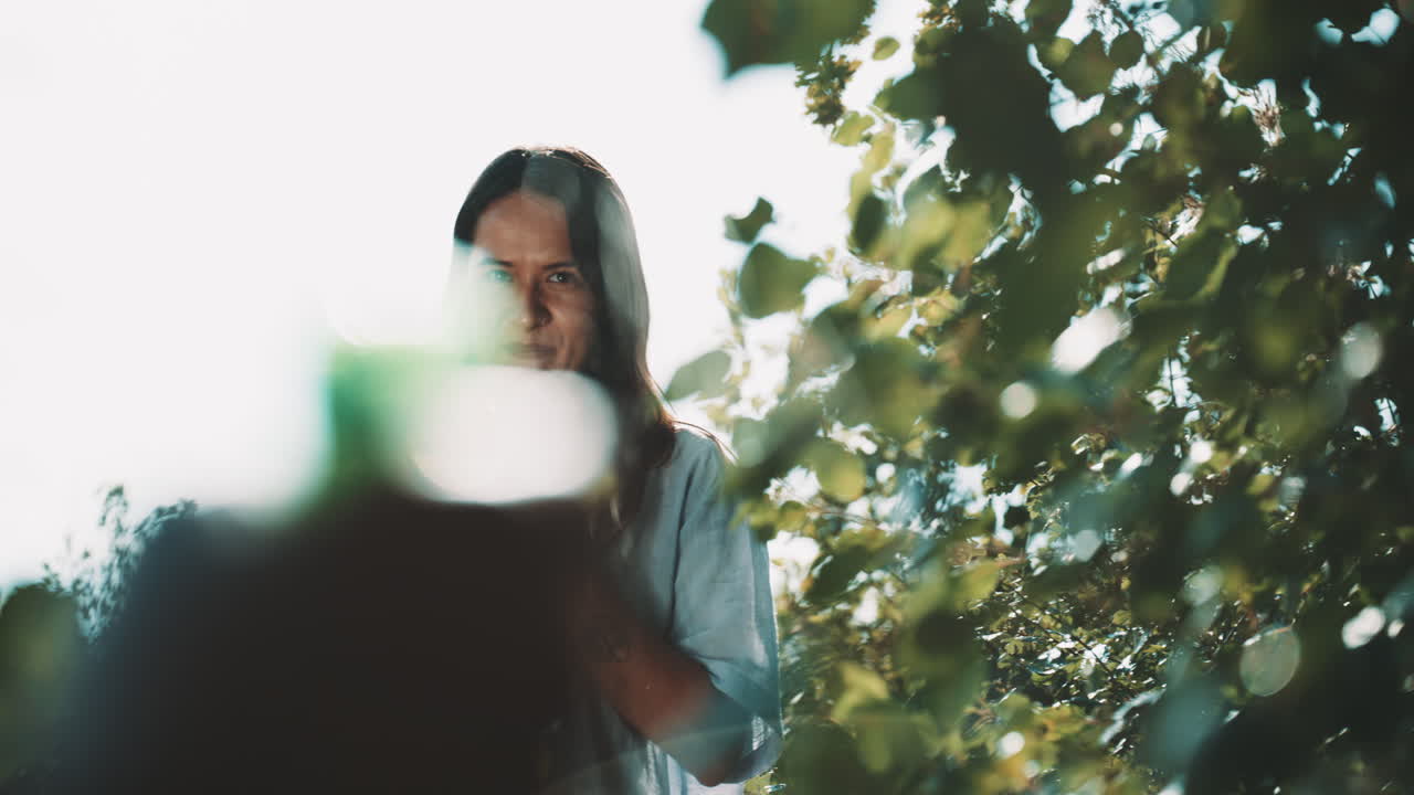 Woman playing with a water gun in a park