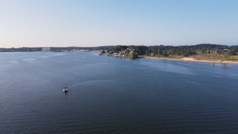 Small-sailing-vessel-on-Lush-summer-waves