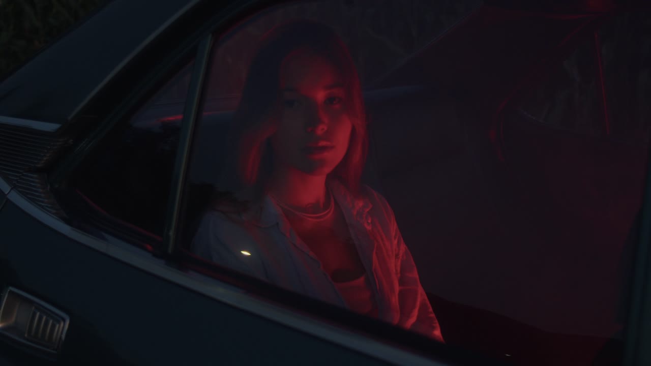 Donna in auto d'epoca di notte