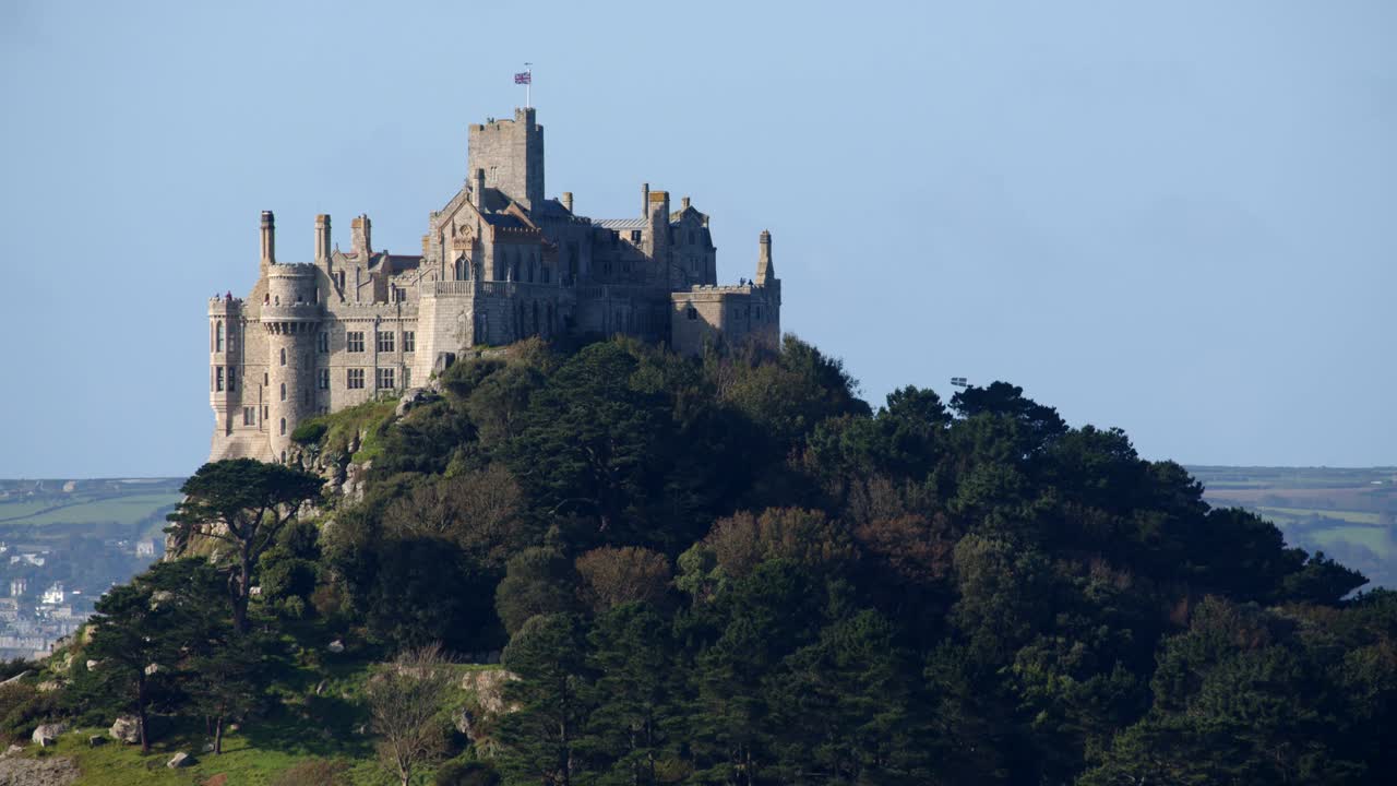 Mid shot of mediaeval castle on St Michael's mount taken from the village of Marazion