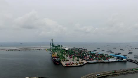 rising aerial of industrial container harbor tanjung priok, indonesia