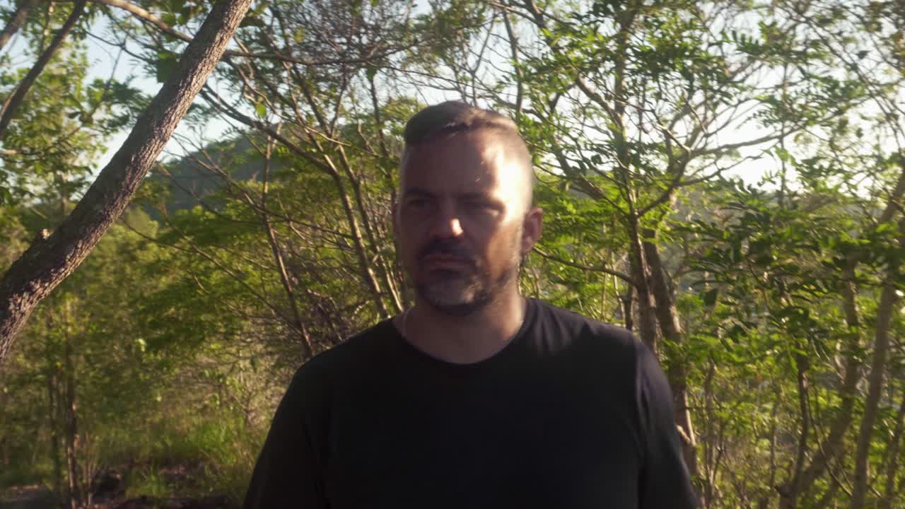 man walking uphill along nature walk.