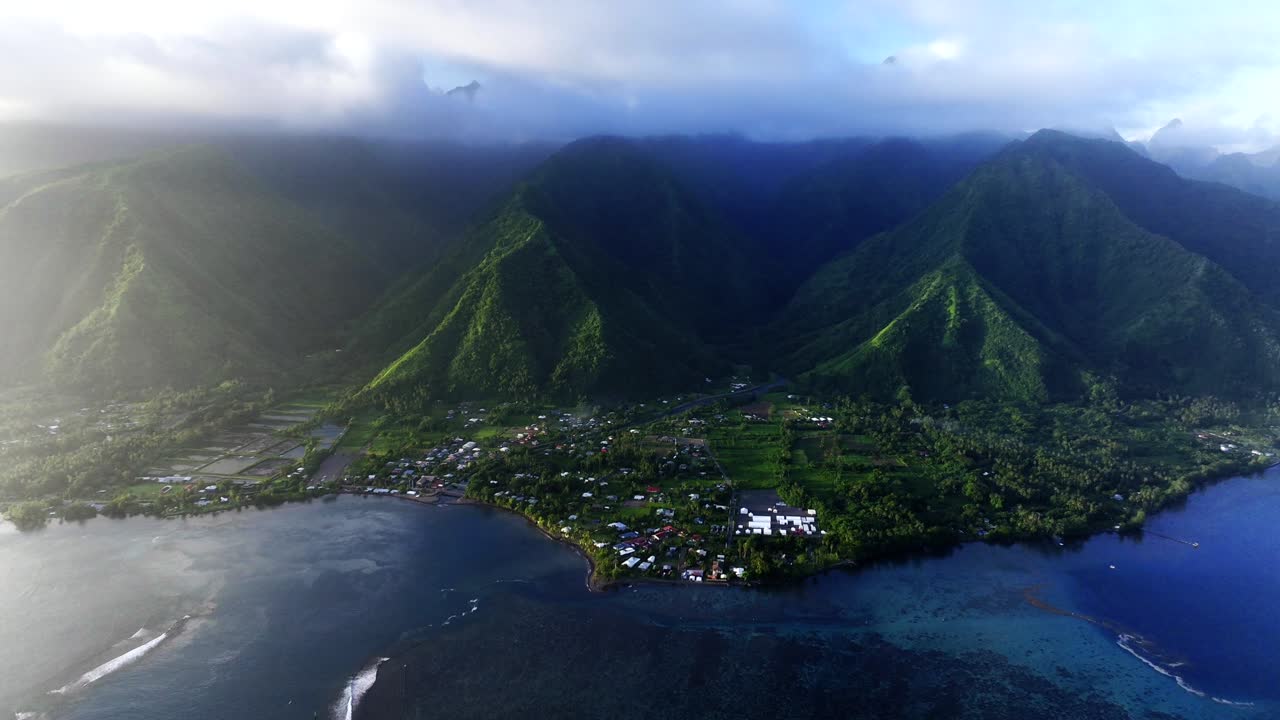 Golden Hour Haze rain clouds layer Teahupoo Tahiti aerial drone island view perspective French Polynesia coastline 2024 surf Pacific Ocean Golden Hour Point Faremahora Pass Havae backwards pan up
