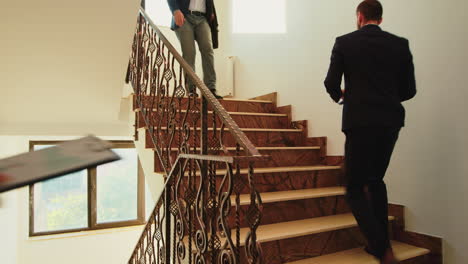 business people climbing stairs in finance corporate building