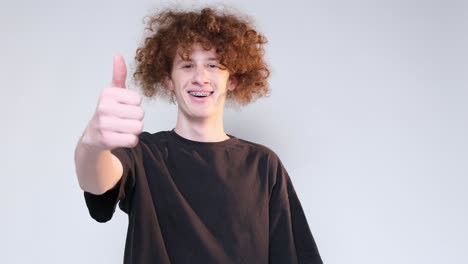 redhead curly haired teenager showing thumbs up redhead curly haired teenager showing thumbs up class hand gesture video