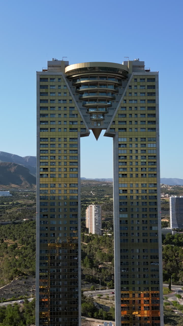 Aerial drone view of the Intempo skyscraper building in Benidorm, Alicante, Spain in daylight. Vertical