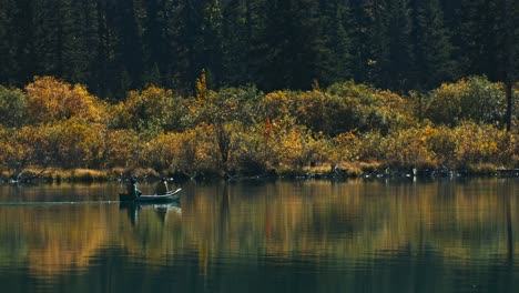 Canoe-on-lake-rowing-by-in-autumn-close-up