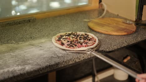 chef preparing pizza toppings in a restaurant kitchen