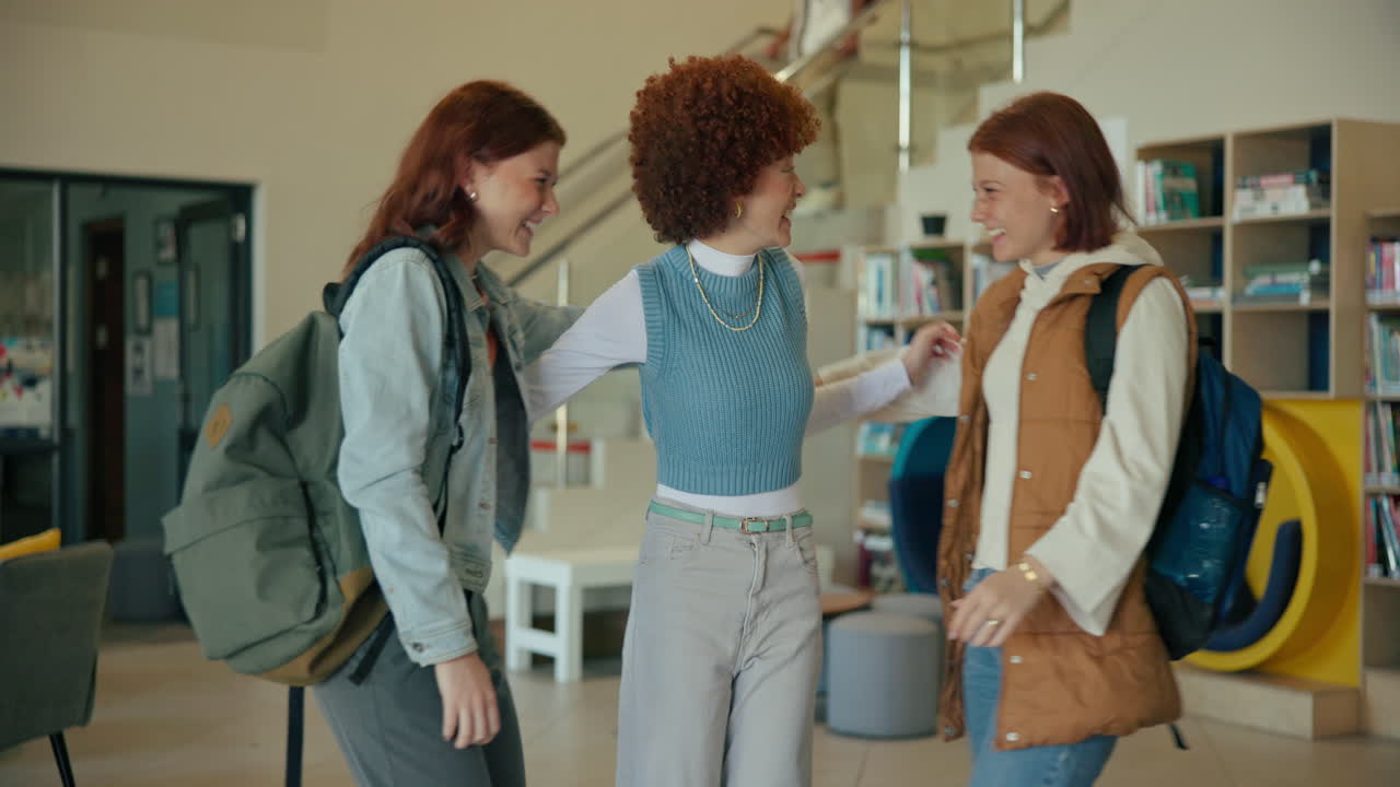 Three Female Students Hugging in School Library