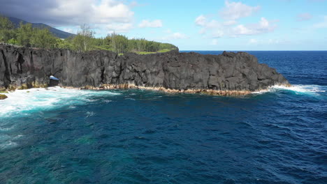 aerial view over the lava rock formation of cap mechant and the coastline of reunion island