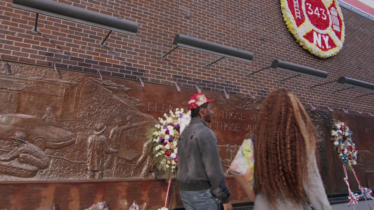 Nine Eleven Fire Department memorial wall with wreaths in New York City, close-up shot in daylight