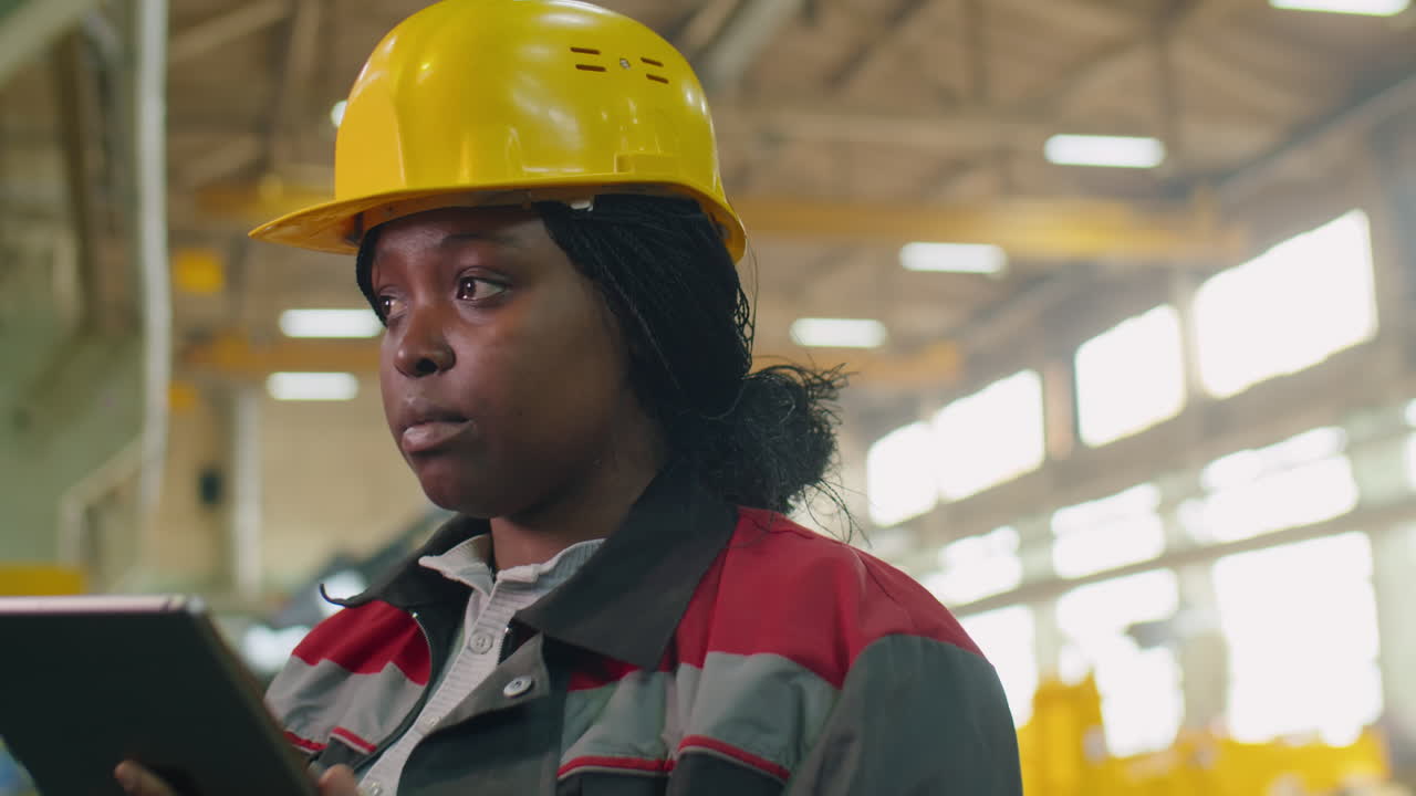 Female Factory Manager Using Digital Tablet