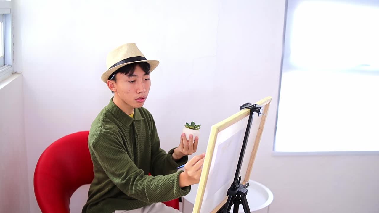 Creative young asian man painting plant for inspiration
