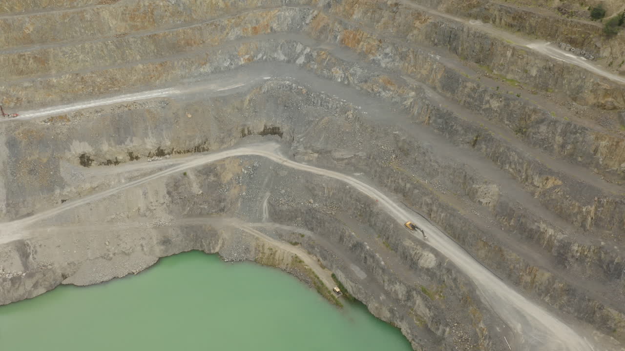Aerial perspective of quarry interior including roads and machinery
