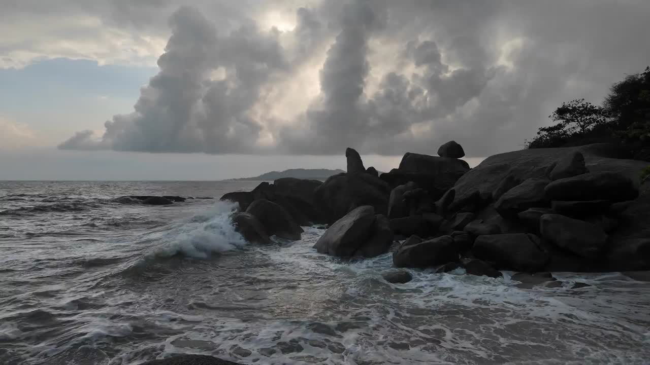 Sea waves collide with the rocky and rugged shores of Koh Samui, Thailand, with untouched natural beauty and the spirit of freedom, travel, and leisure